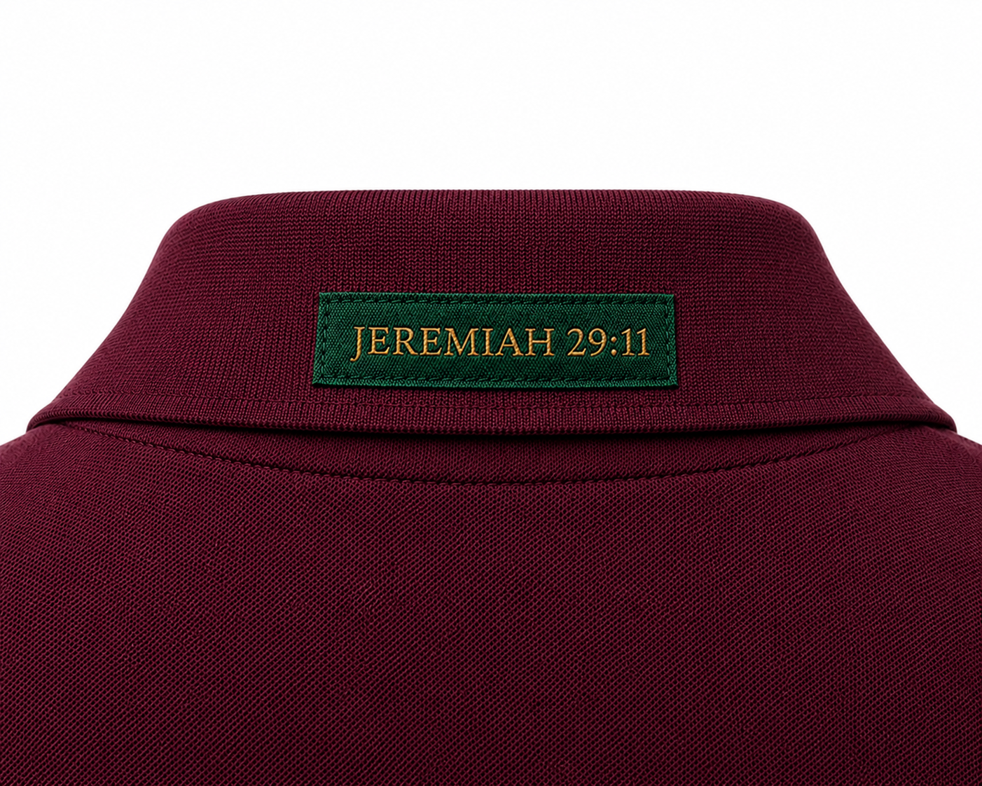 The Verse Polo™ in Burgundy — back collar detail showing the Ordinary green verse patch, Jeremiah 29:11