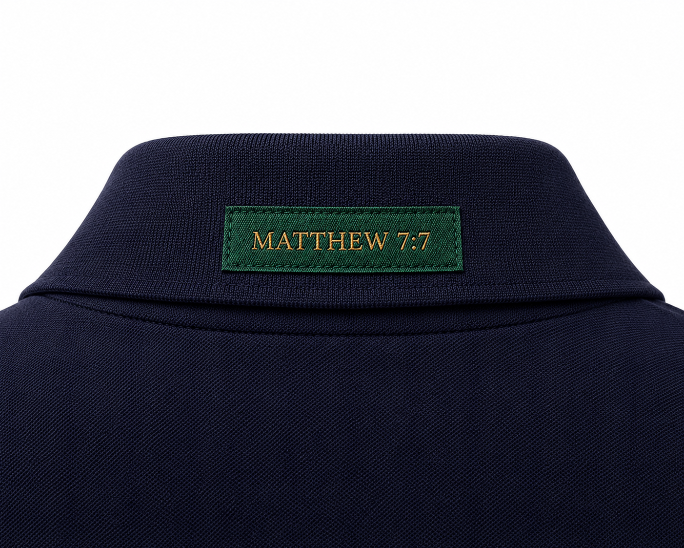 The Verse Polo™ in Navy — back collar detail showing the Ordinary green verse patch, Matthew 7:7