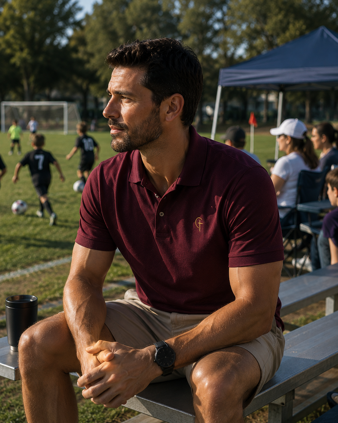 The Verse Polo™ in Burgundy — worn, lifestyle shot at a kids' soccer game